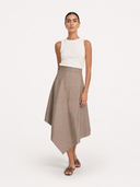  White ribbed knit tank top paired with beige wool-blend asymmetric midi skirt cut in a fine pinstripe