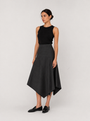 Black ribbed knit tank top with a grey wool-blend midi skirt cut in a fine pinstripe
