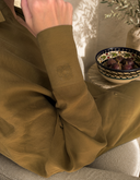 Nawa Olive relaxed button-down shirt with drop shoulder and long sleeves with Nawá monogram embroidered cuffs
