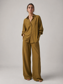 Nawa Olive relaxed button-down shirt  in lightweight modal with dropped shoulders and button-front closure in a set with Nawa Olive wide leg tailored trousers with high waistband and side pockets



